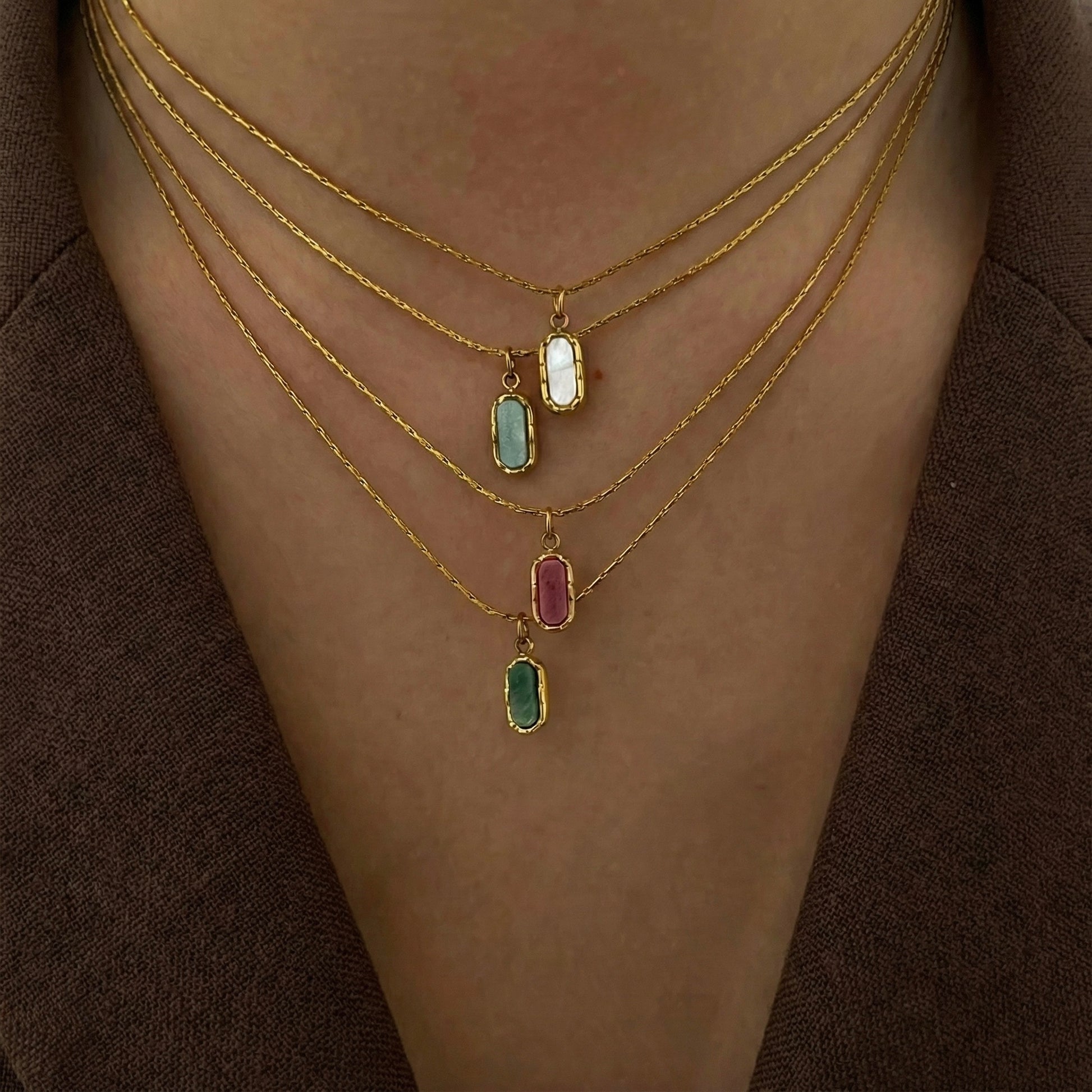 Aera gold pendant necklace styled in a Lumé Lumé lifestyle image