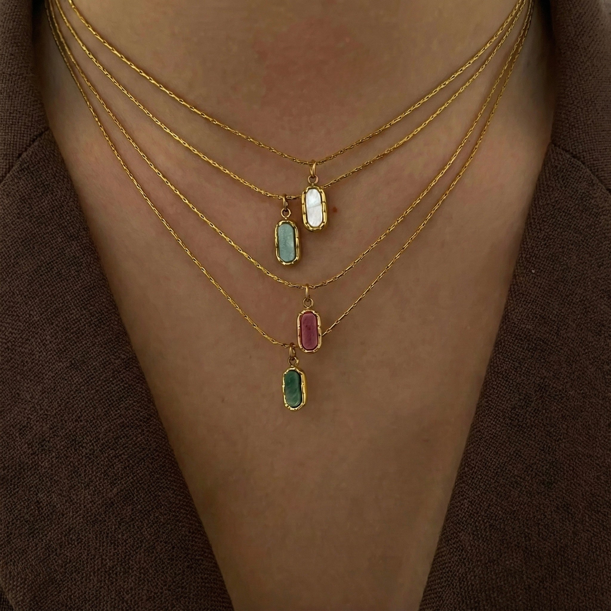 Aera gold pendant necklace styled in a Lumé Lumé lifestyle image