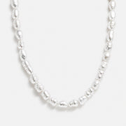 Lumière Pearl Necklace with freshwater pearls and gold details by Lumé Lumé